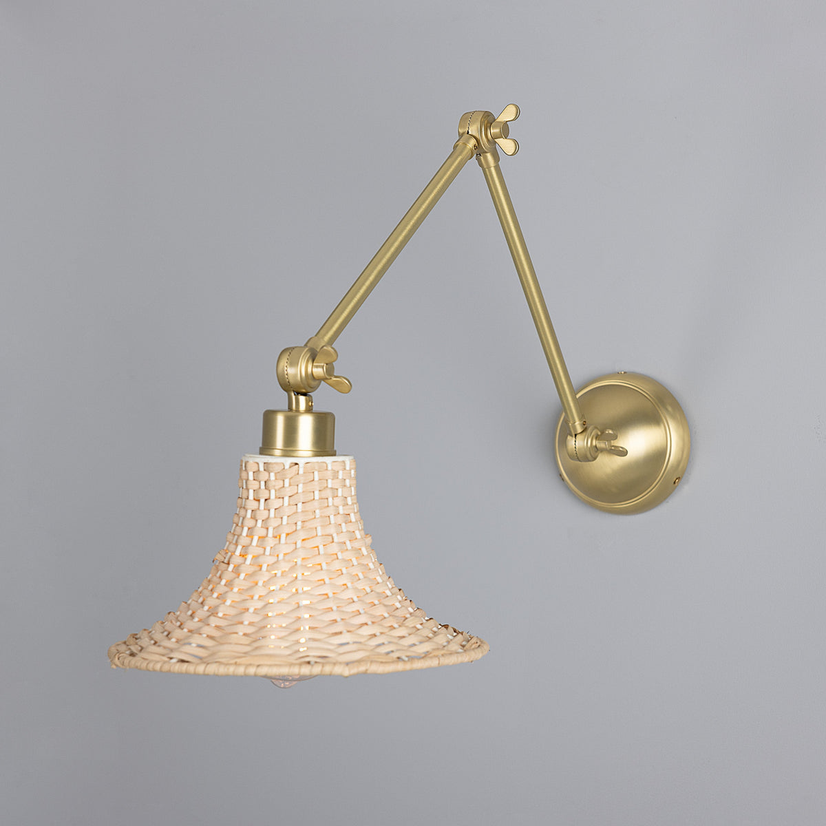 Savannah Adjustable Arm Wall Light in Satin Brass with Small Bell Shaped Rattan Shade