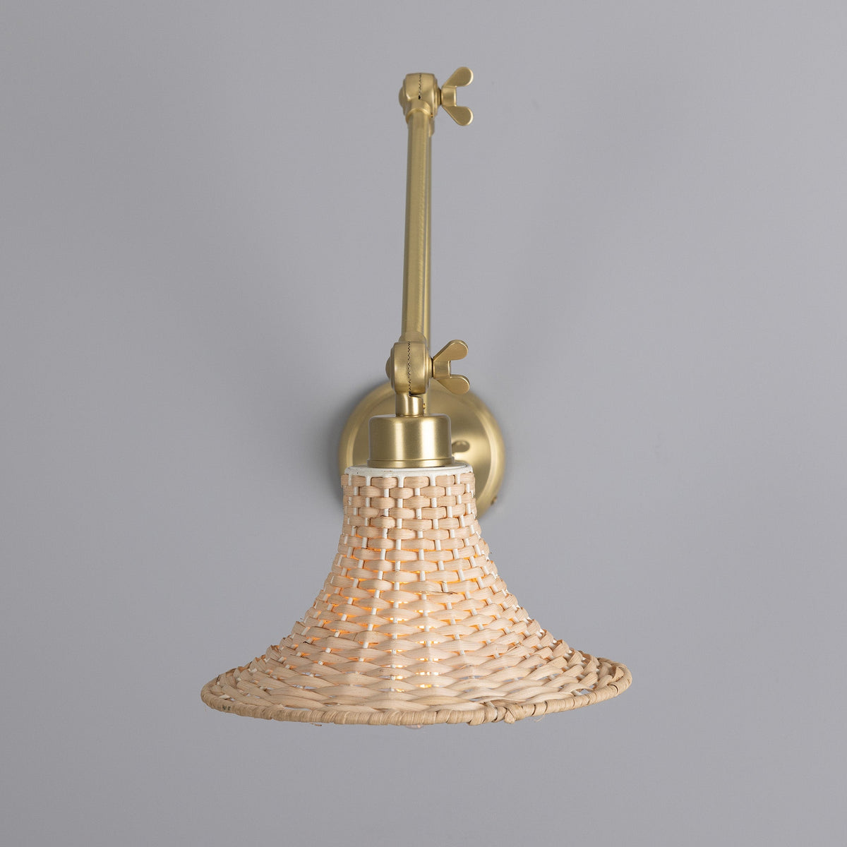 Savannah Adjustable Arm Wall Light in Satin Brass with Small Bell Shaped Rattan Shade