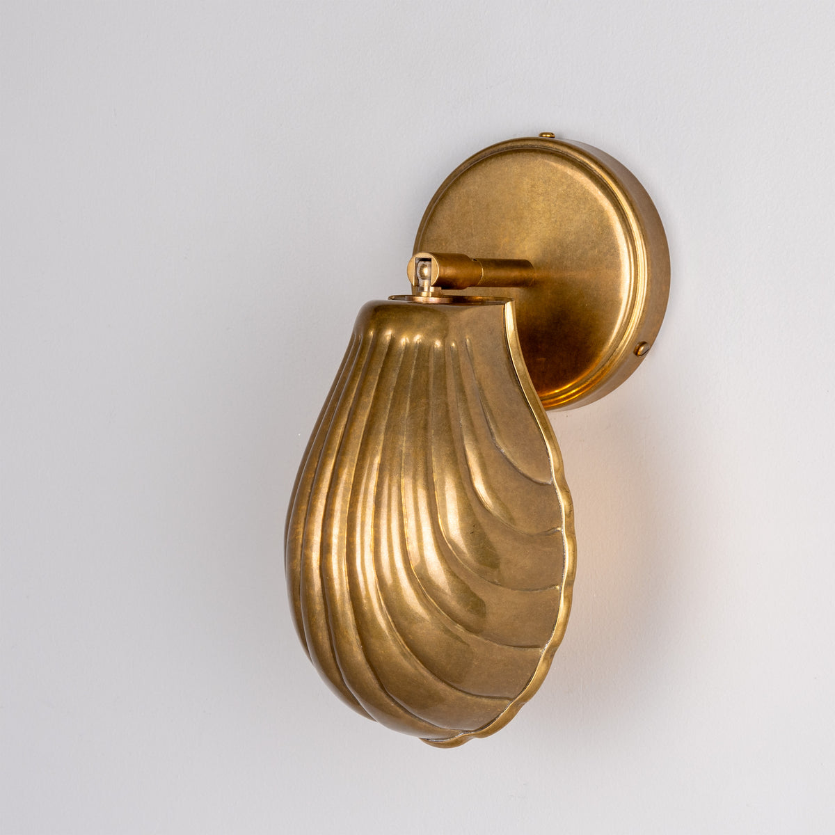 Shell Adjustable Brass Wall Light in Antique Brass