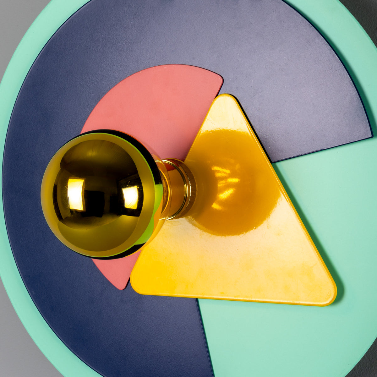Mullan Earth Colourful Disc Wall Light in Polished Brass featuring geometric shapes in blue pink yellow and green