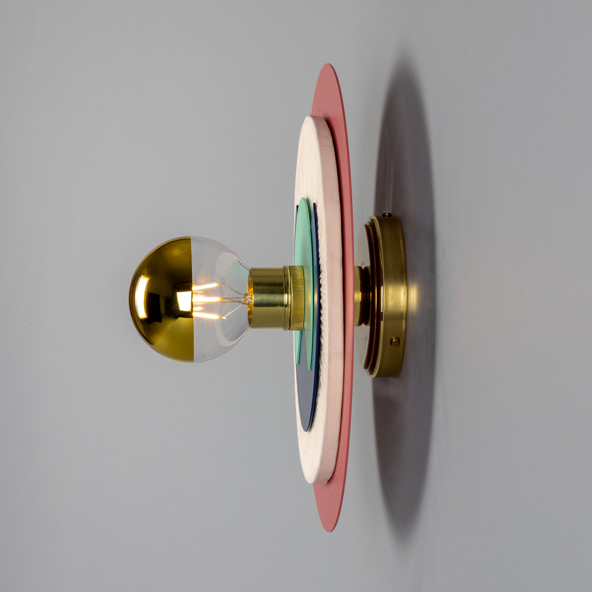 Mullan Saturn colourful disc wall light in polished brass with layered circular plates and a half-dipped gold bulb