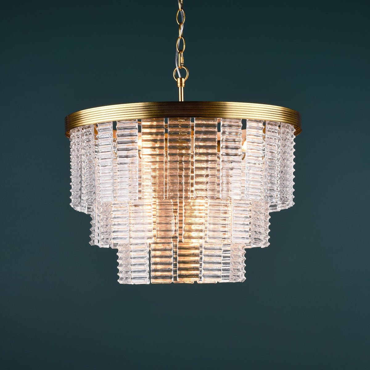 Tiered chandelier with clear glass rods and a brass frame