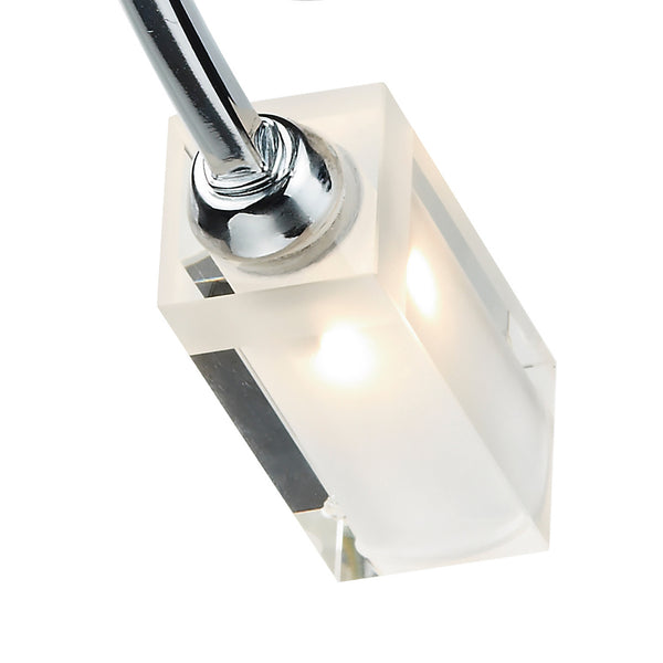Close-up of a modern light fixture with a chrome arm and a frosted rectangular glass shade.