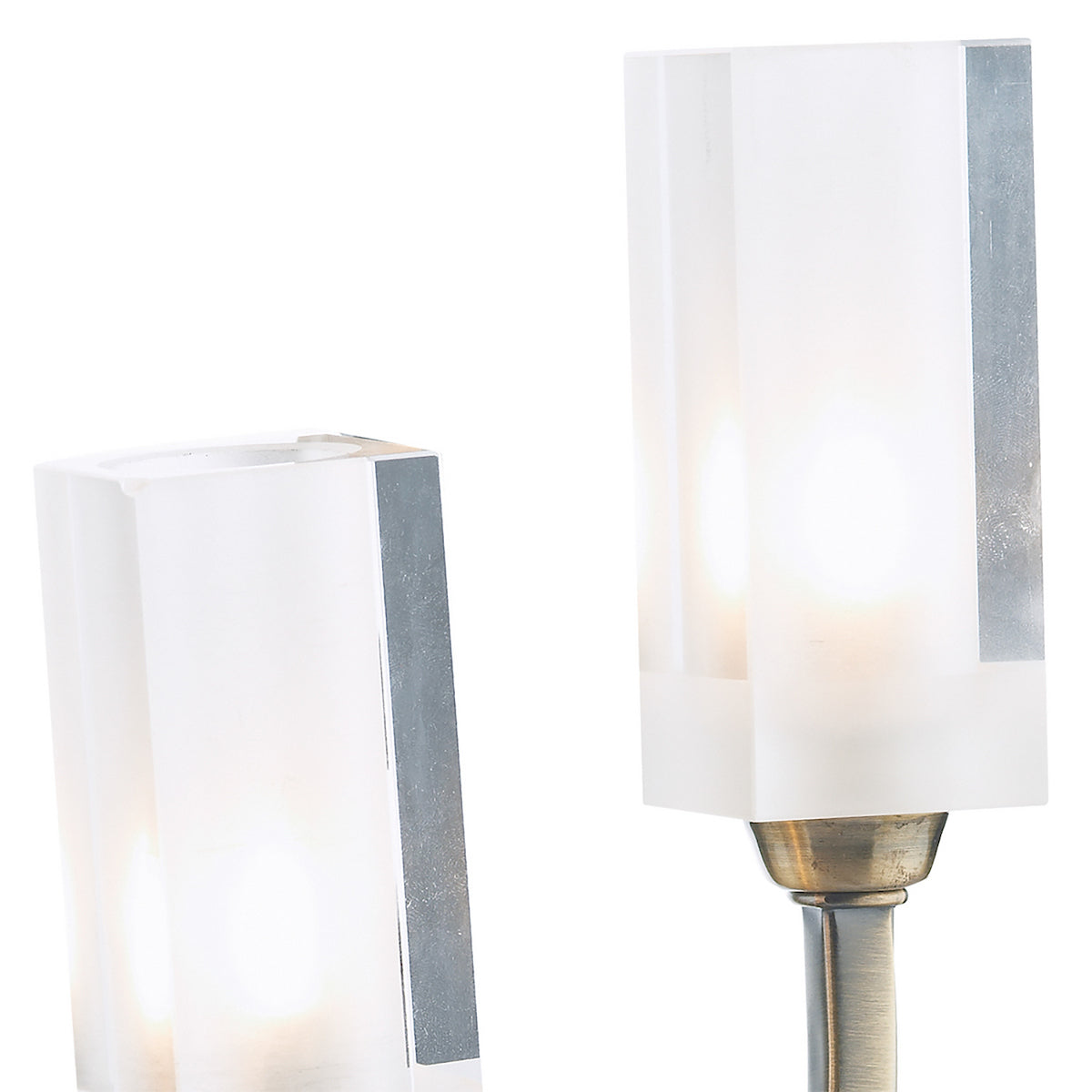 Two frosted glass light shades with a bronze base on the right.