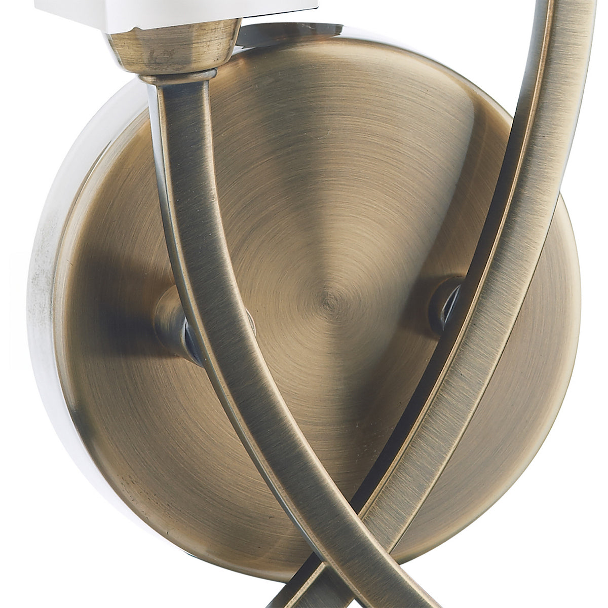 Close-up of a brushed brass wall light fixture with curved arms.