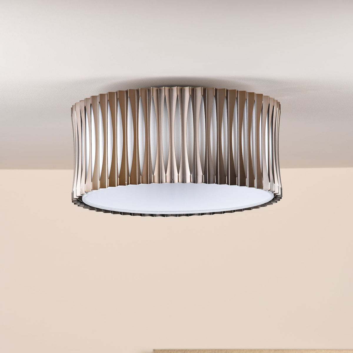 Round ceiling light with a brushed bronze finish and a white diffuser