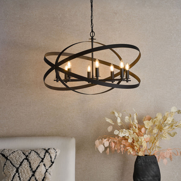 Black metal chandelier with six exposed bulbs, featuring intersecting orbital bands, hanging in a room.