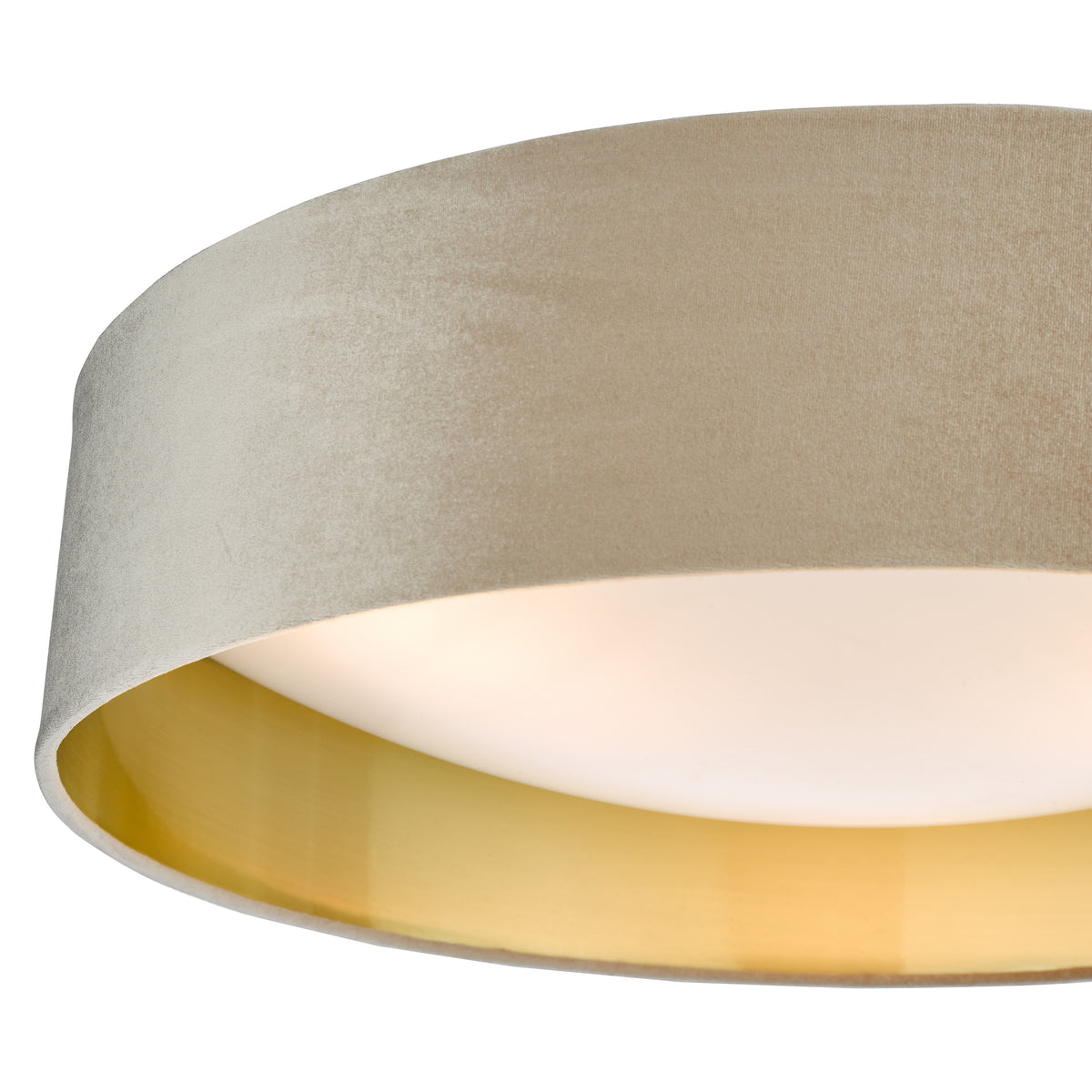 Close up of a beige velvet lampshade with a gold interior