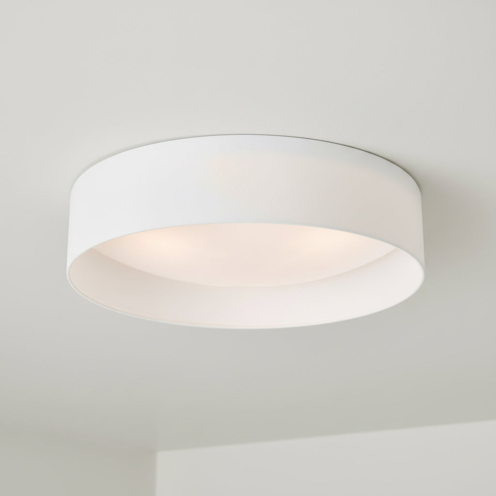 White drum ceiling light fixture with a soft glow