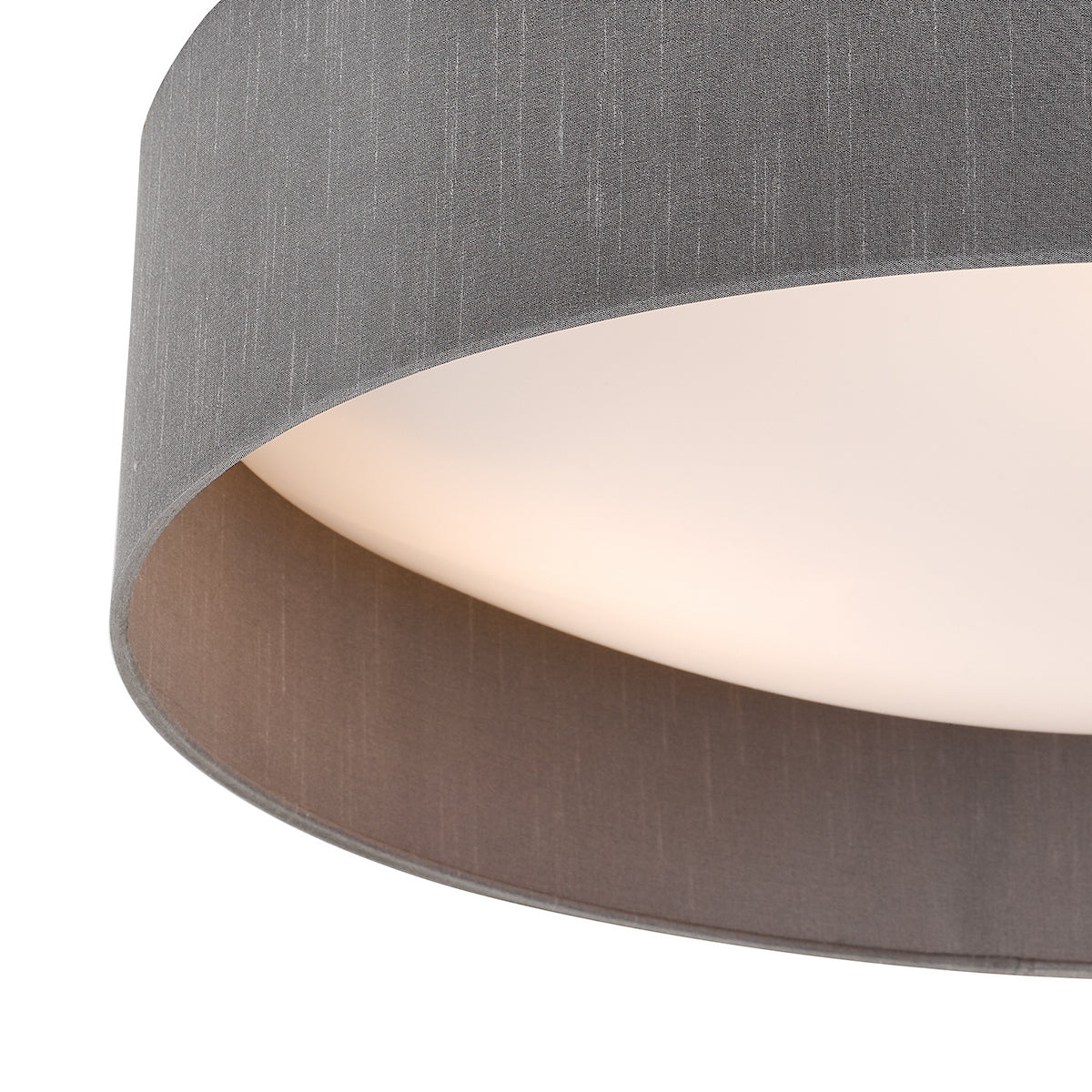 Close up of a grey fabric lampshade with a white diffuser