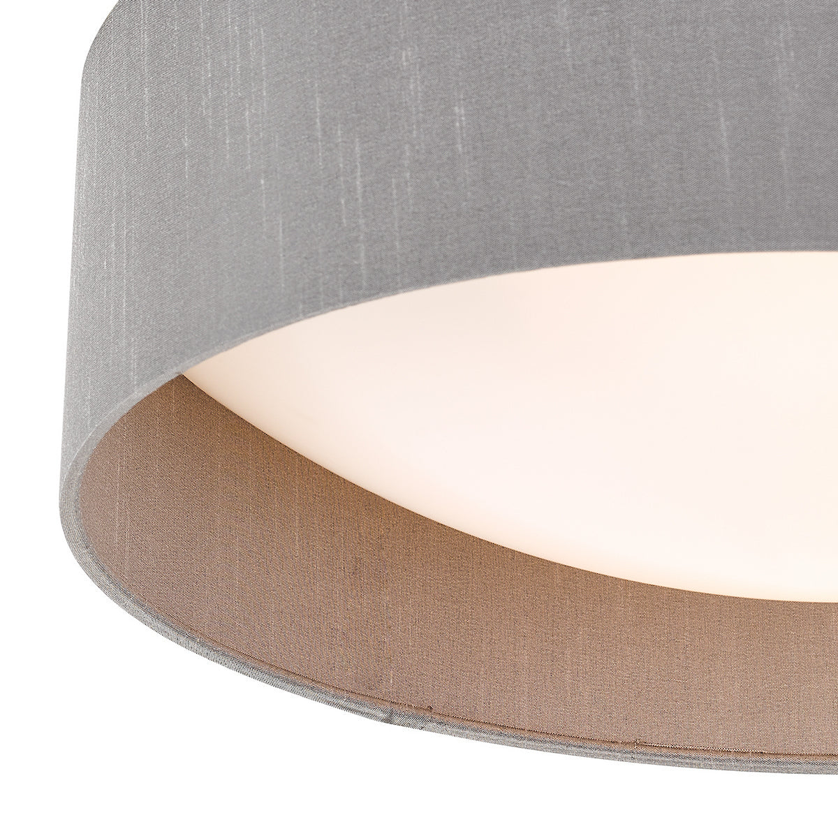 Close up of a grey fabric lampshade with a brown interior