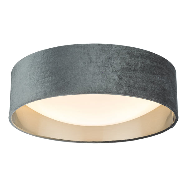 Round ceiling light with a grey velvet shade and a gold interior, illuminated from within