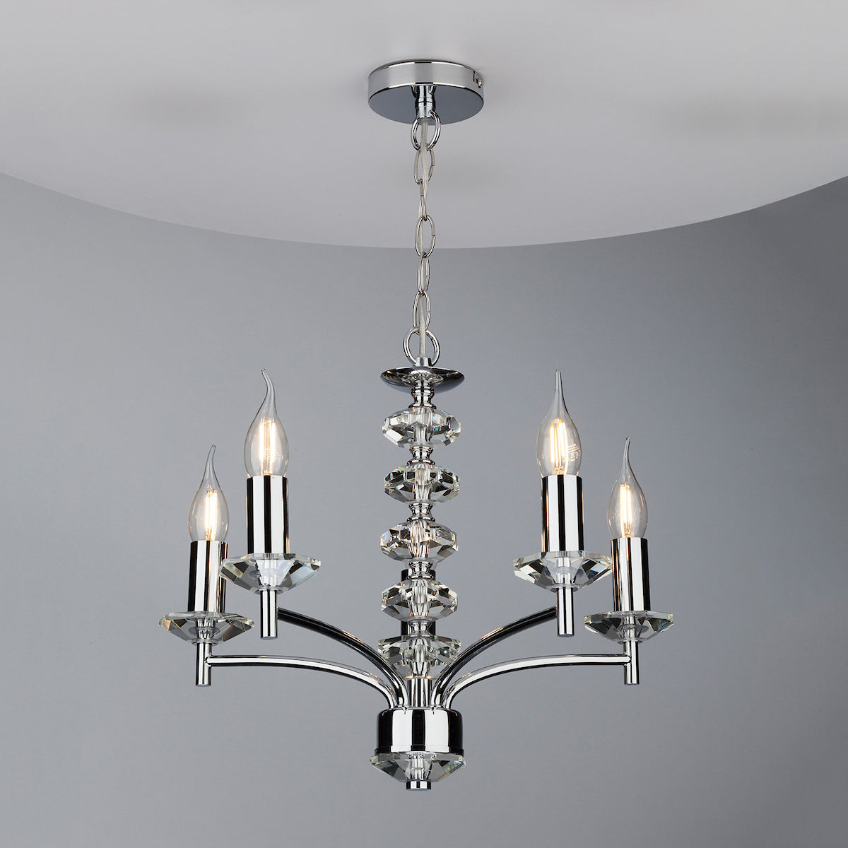 Chrome chandelier with four candle-style bulbs and crystal accents.