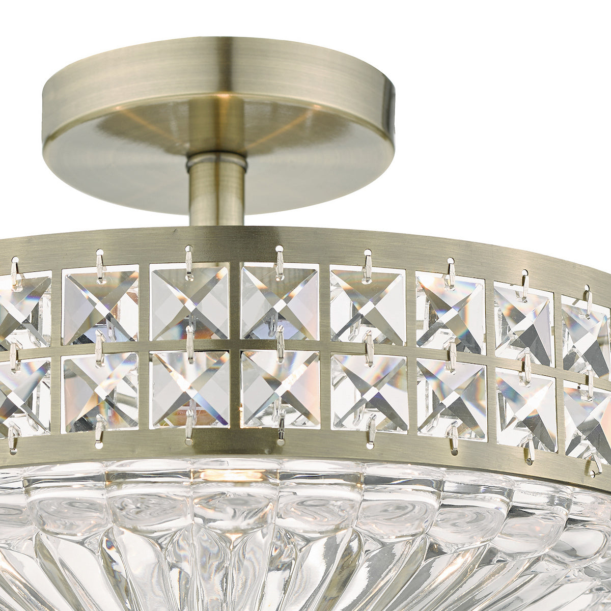 Close-up of a semi-flush mount ceiling light with a bronze finish and square crystal accents.