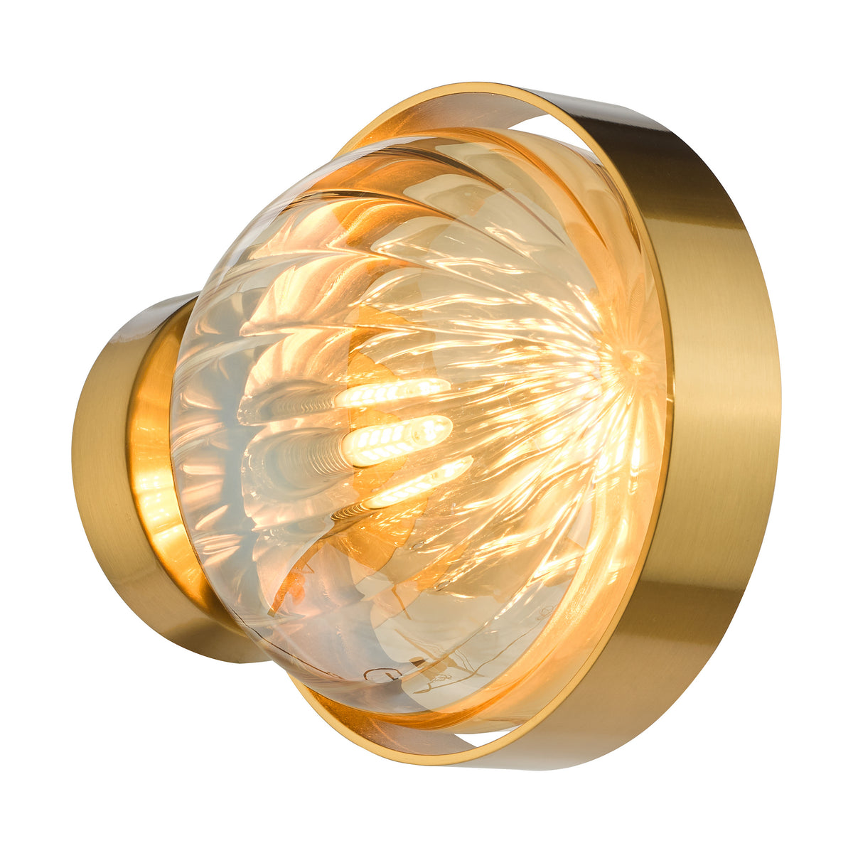 A modern brass wall sconce with a clear, textured glass shade, emitting a warm glow.