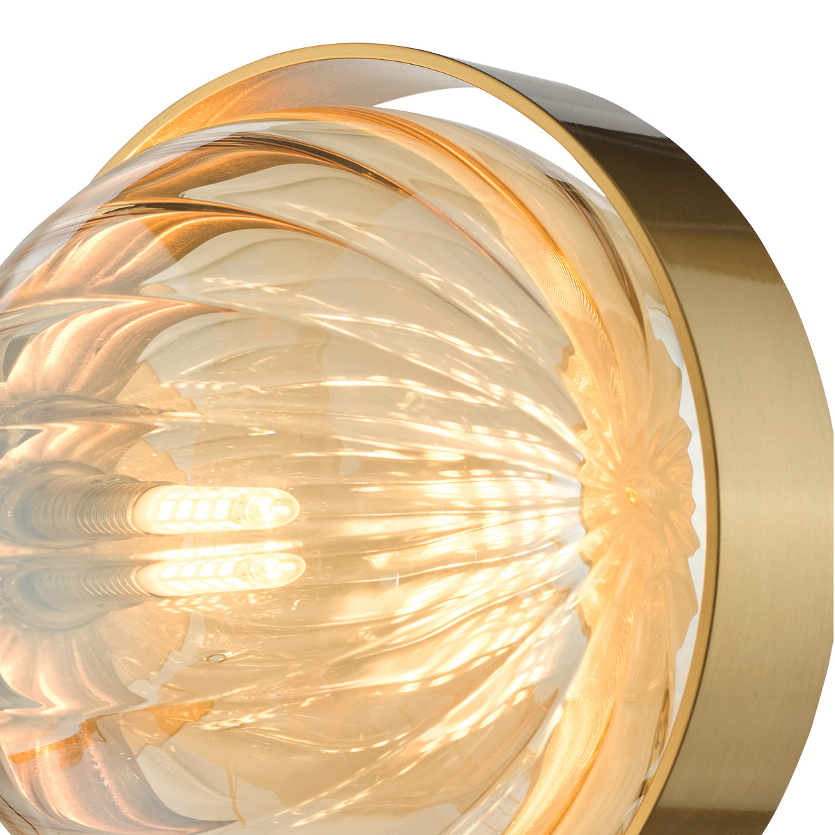 Close-up of a modern wall light with a gold frame and a textured amber glass shade.