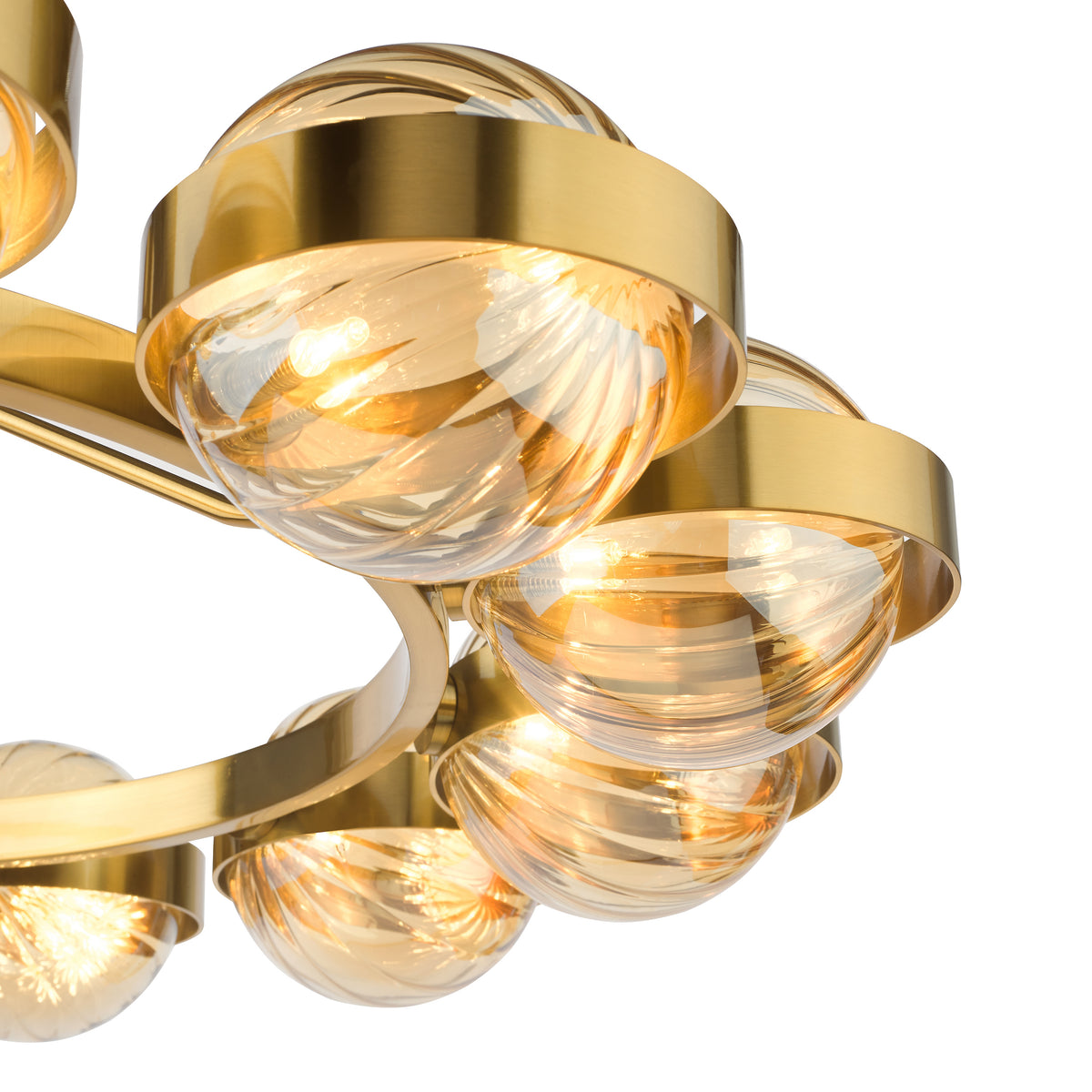 Close-up of a modern brass chandelier with multiple amber glass globes, each illuminated from within.