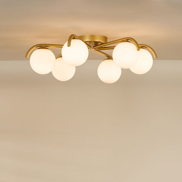 Gold ceiling light with six white globe shades