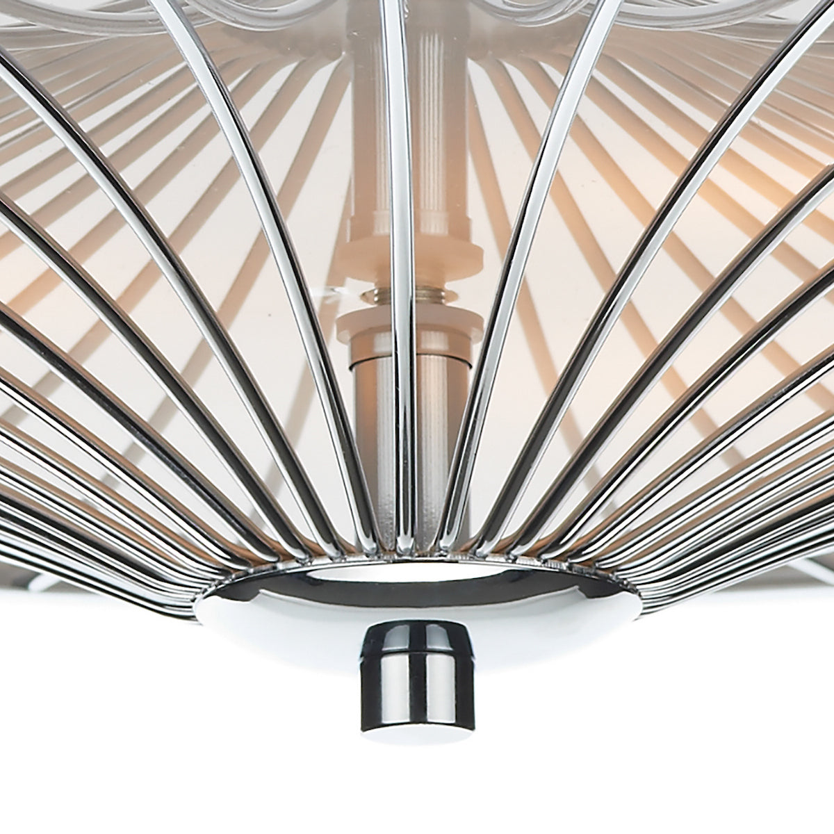 Close-up of a chrome light fixture with radiating metal rods and a central bulb.