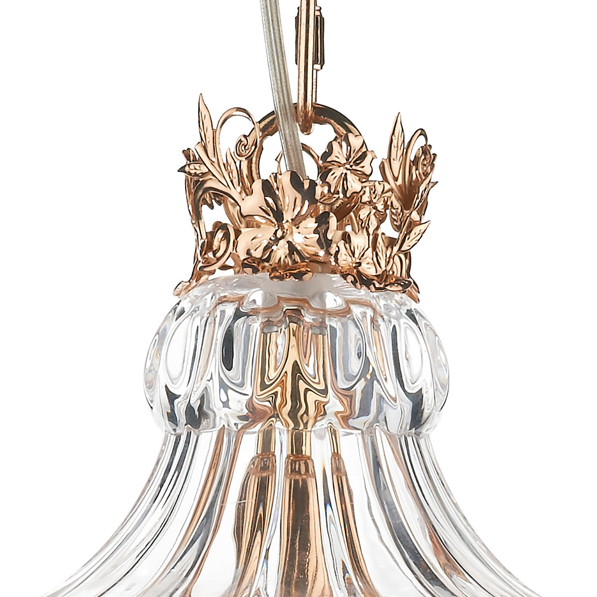 Close-up of a gold and clear glass chandelier with floral details.