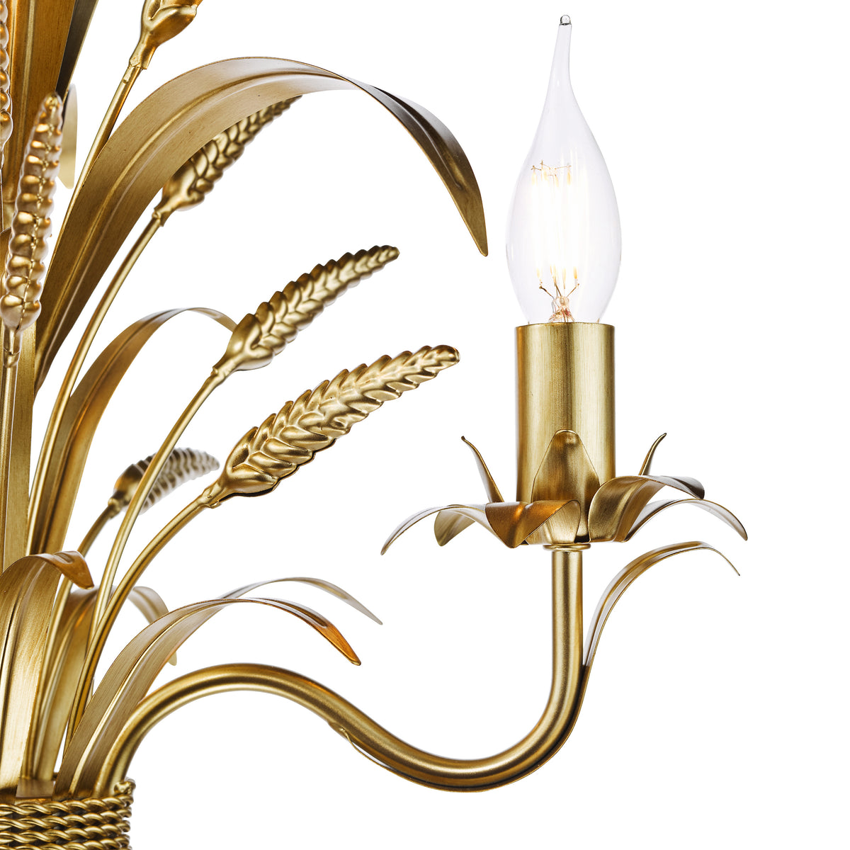 Close up of a gold chandelier with wheat stalk details and a single candle-shaped light bulb