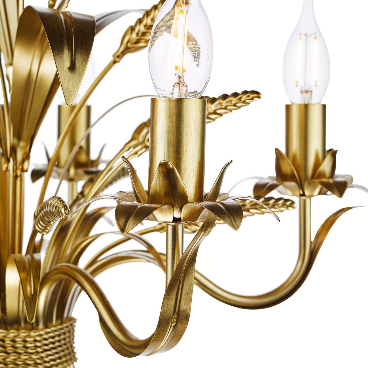 Close up of a gold chandelier with light bulbs and decorative leaves