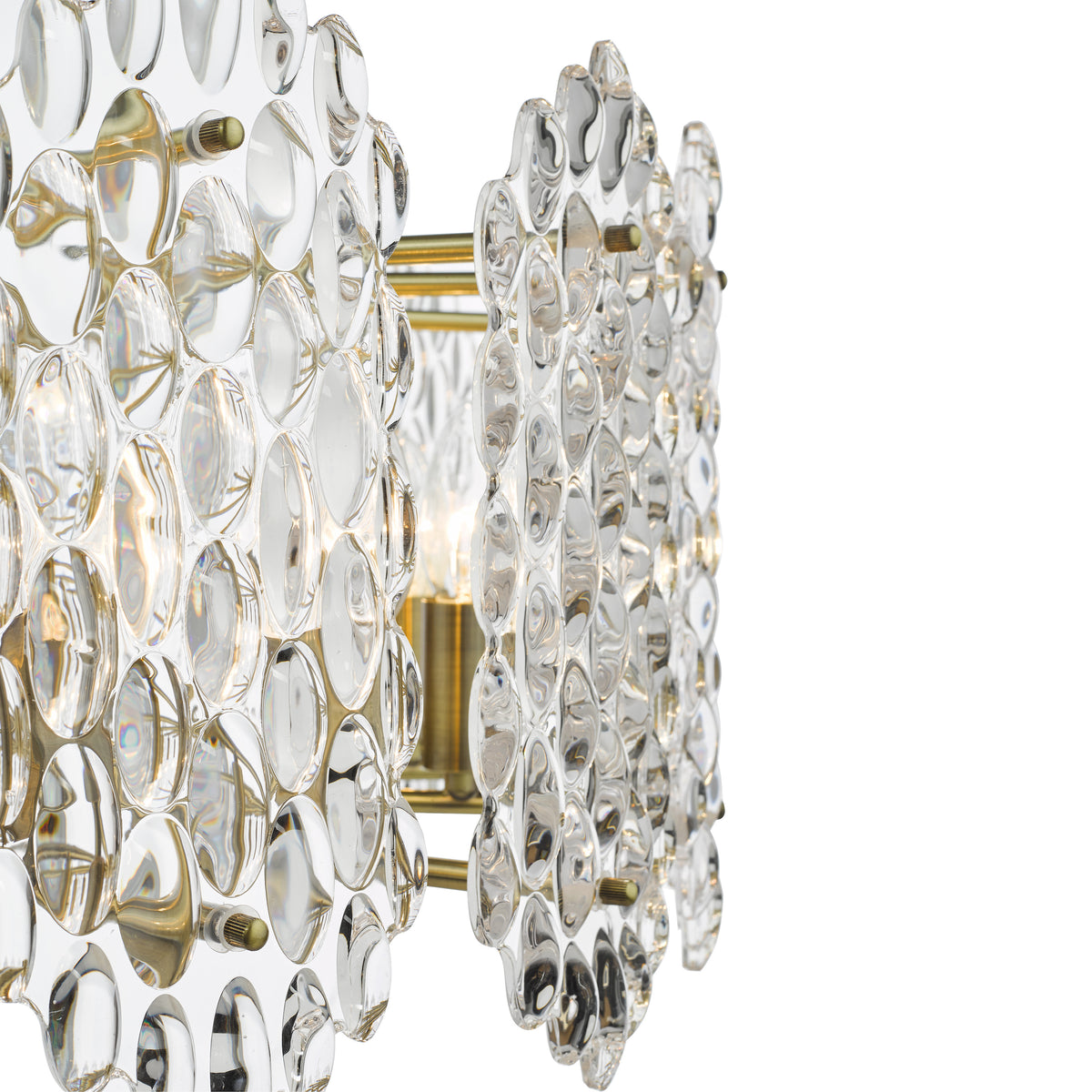 Close up of a glass and brass wall sconce with a lightbulb in the center