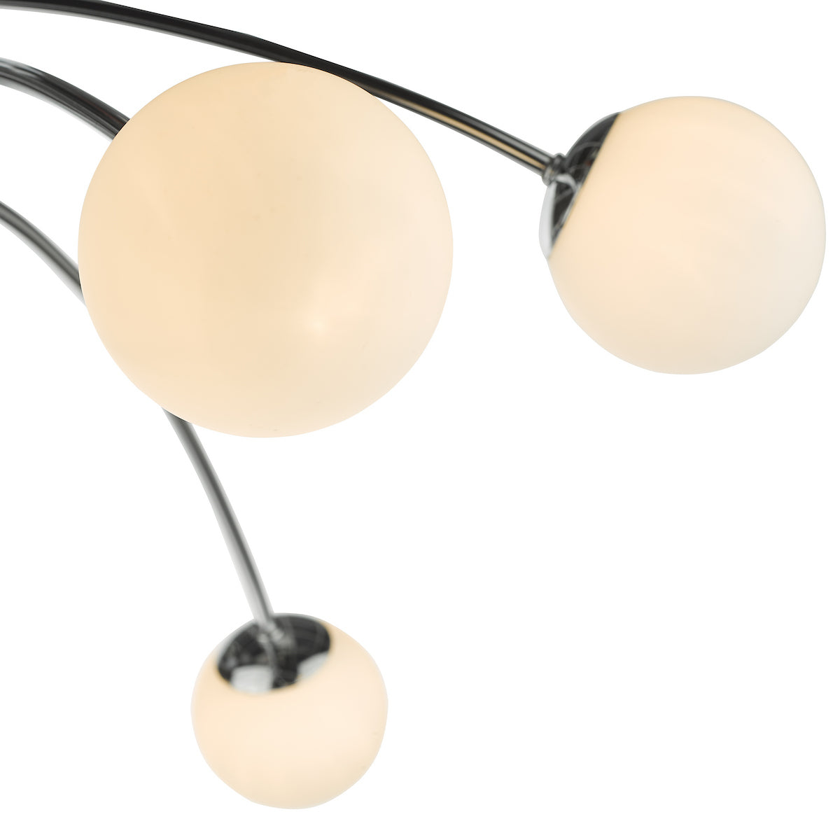 Close-up of a modern light fixture with three spherical, frosted glass bulbs on curved metal arms.