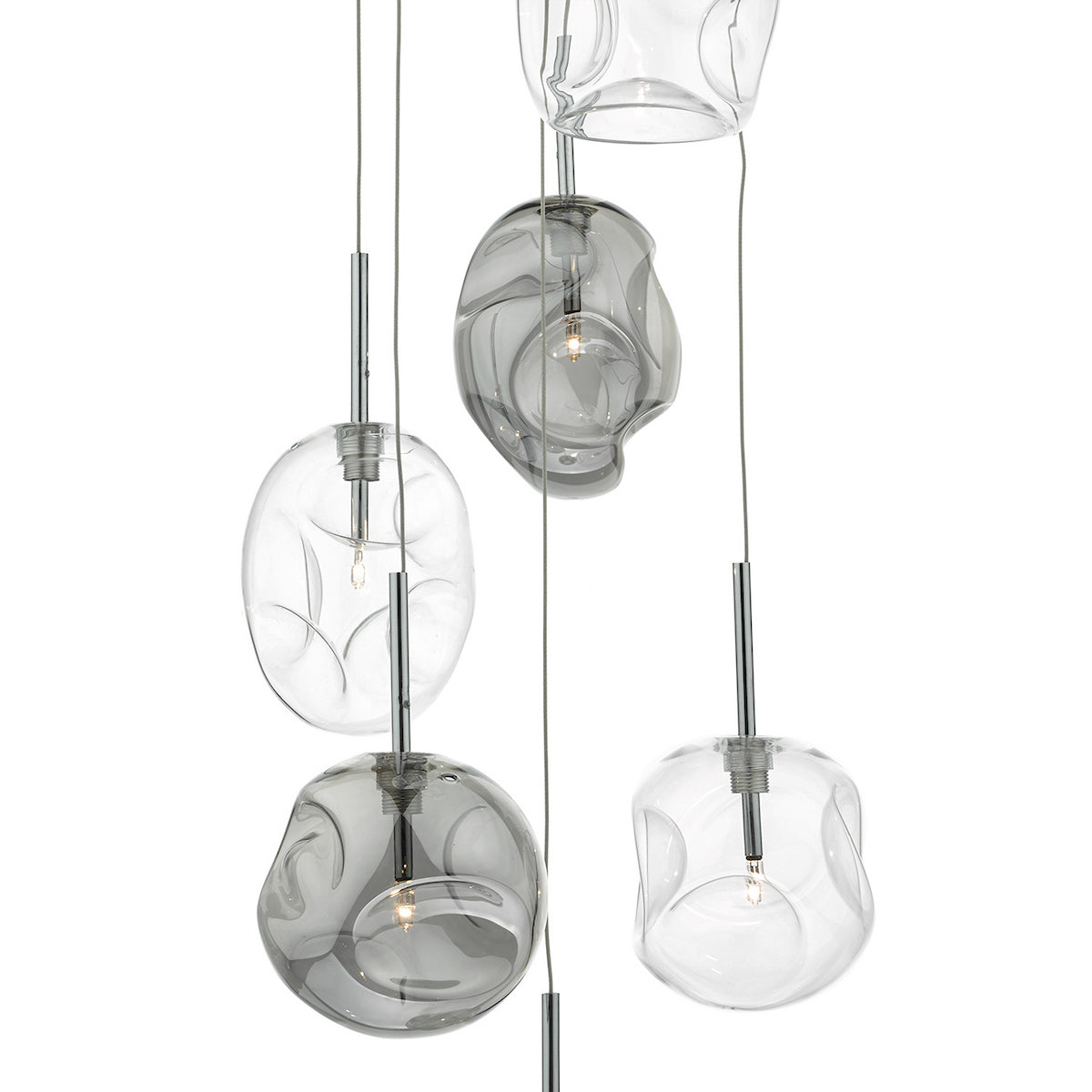 Five clear and gray glass pendant lights with organic, irregular shapes hang from thin wires.