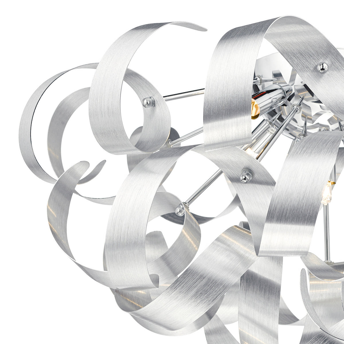Close-up of a modern chandelier with brushed aluminum ribbons and exposed bulbs.