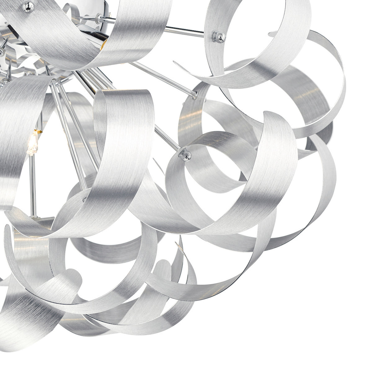 Close-up of a modern chandelier with brushed silver metal ribbons forming a spherical design.