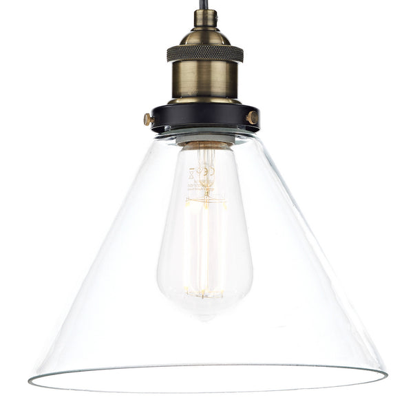 Clear glass cone pendant light with an Edison bulb and antique brass fitting.