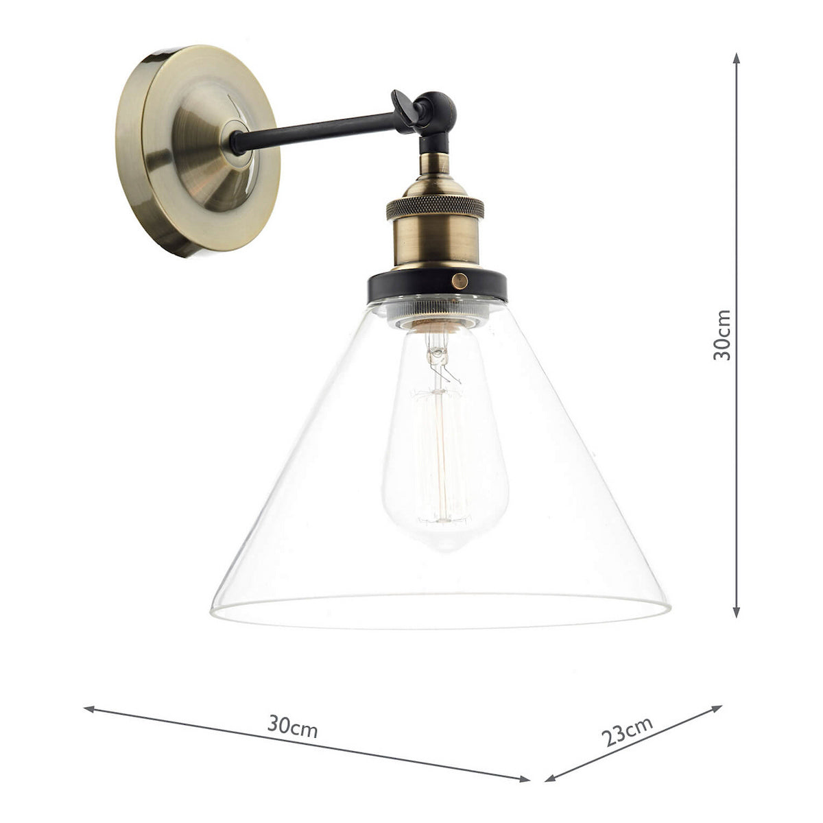 Vintage brass wall light with a clear glass cone shade and exposed filament bulb.