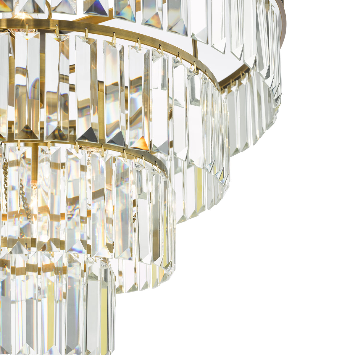 Close up of a tiered chandelier with rectangular crystal prisms and a brass frame