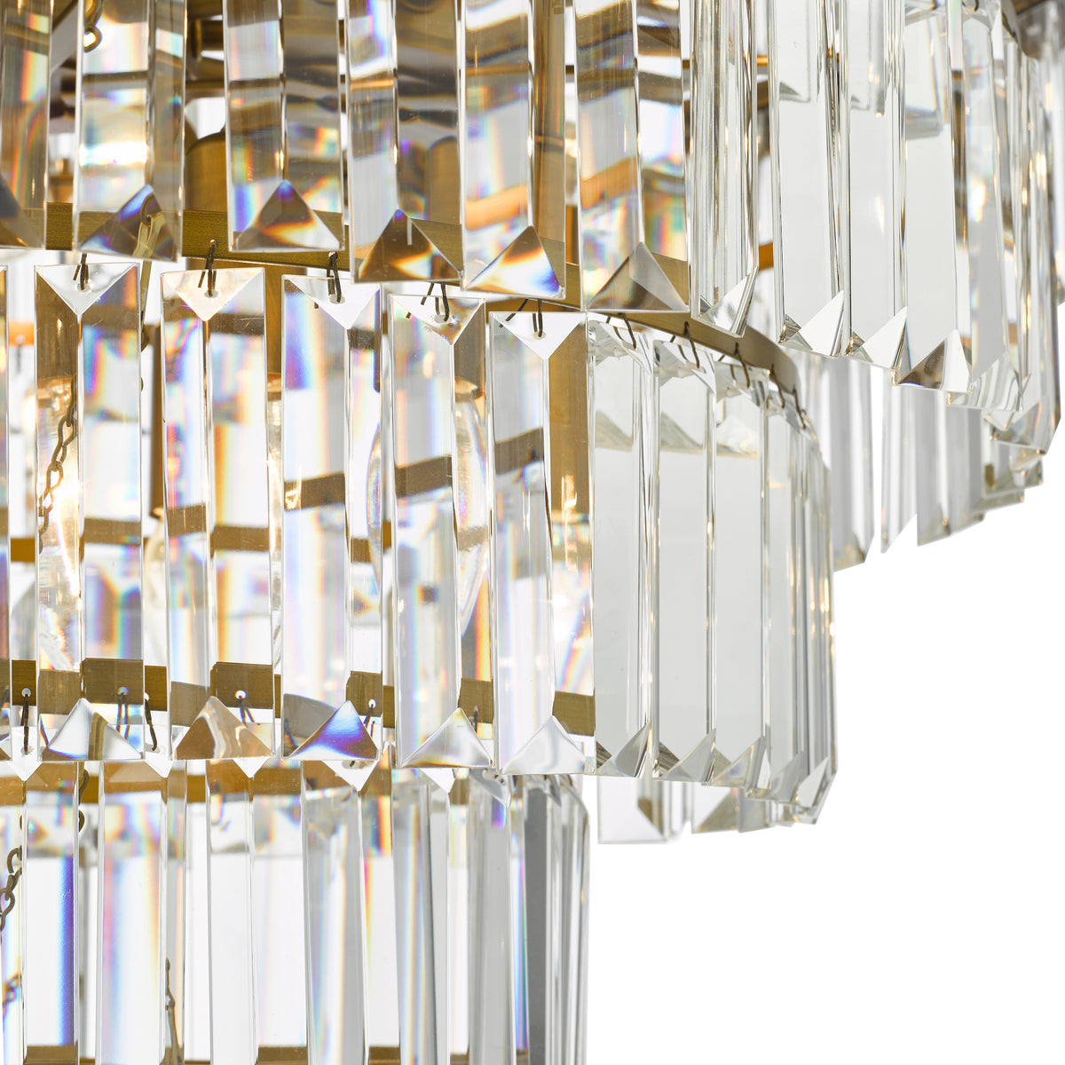 Close up of a crystal chandelier with rectangular prisms and triangular facets reflecting light