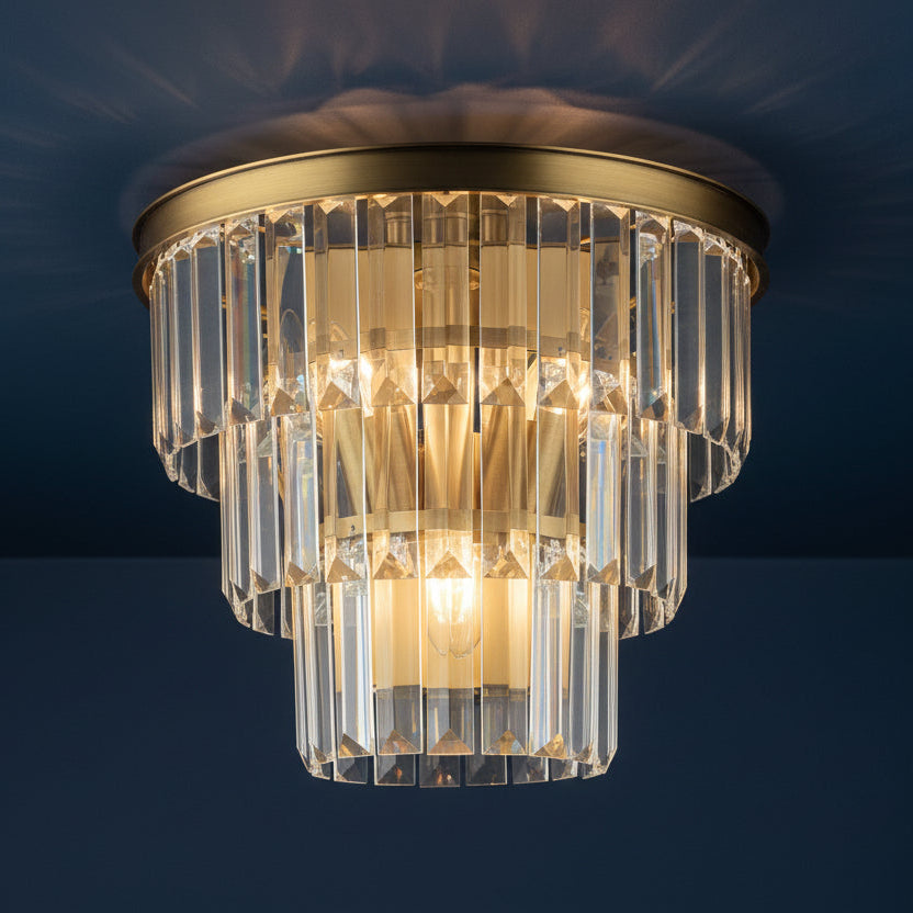 Tiered crystal flush mount light fixture with brass accents