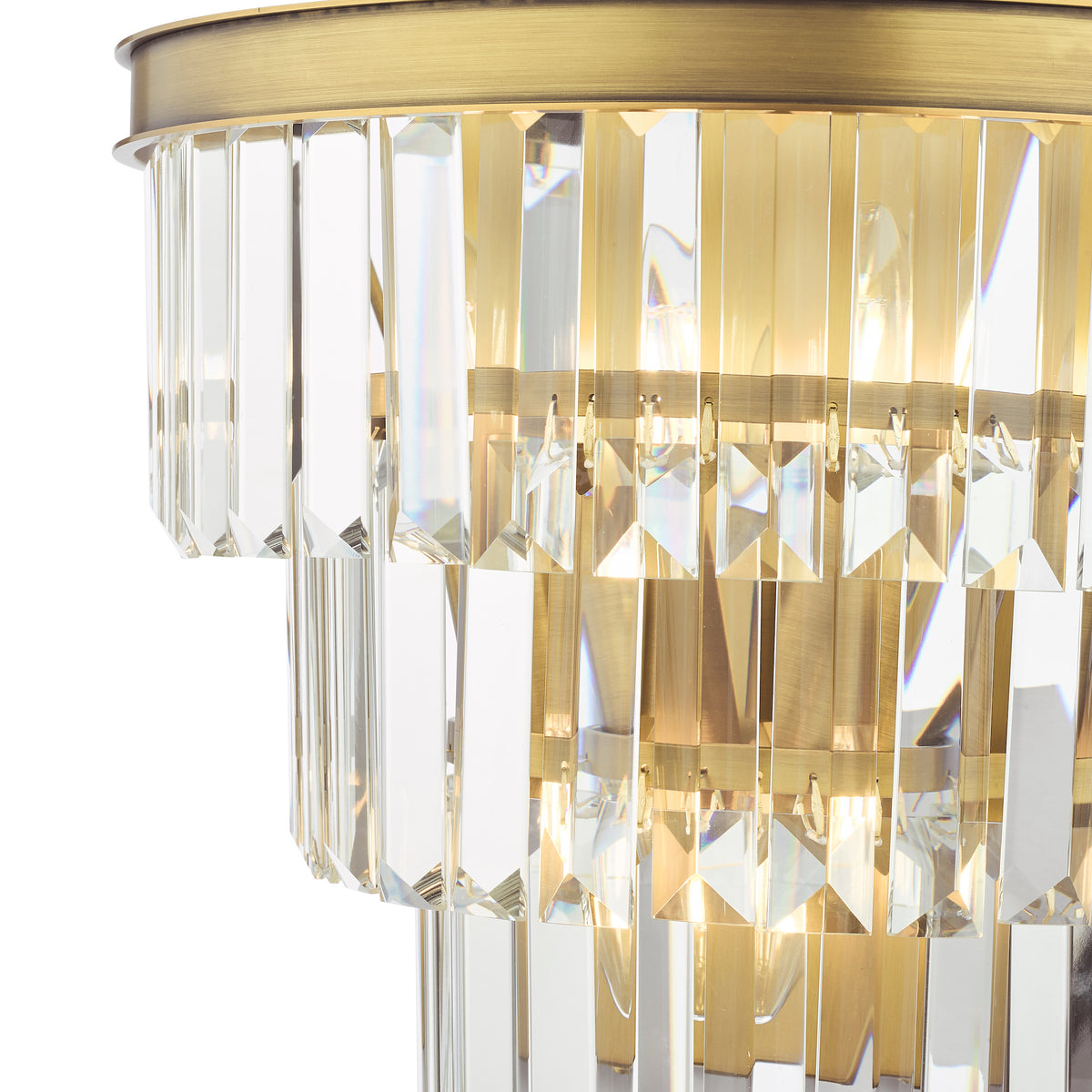 Close up of a two-tiered chandelier with rectangular crystal prisms and a brushed brass frame