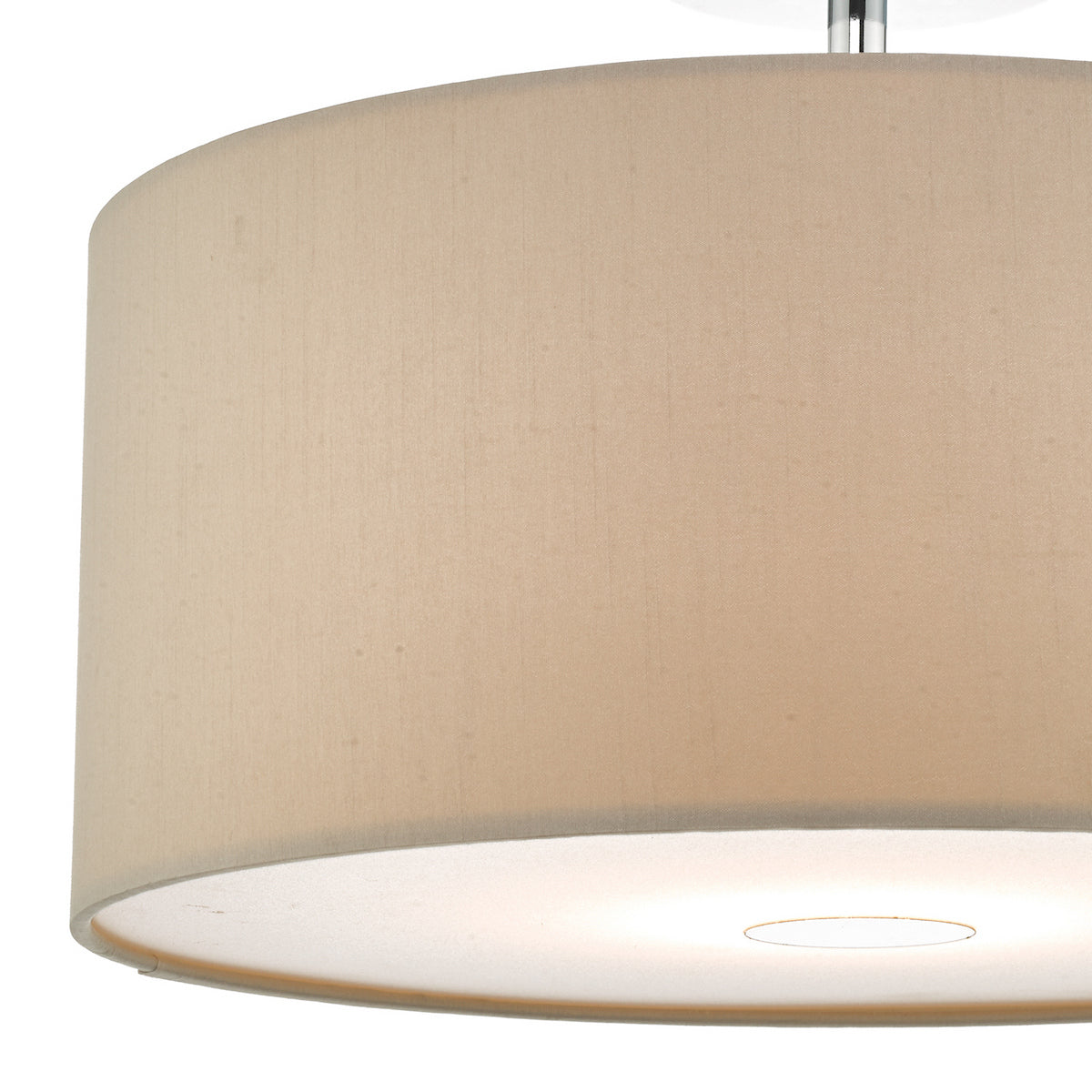 Close-up of a beige fabric drum lampshade with a glowing light from below.