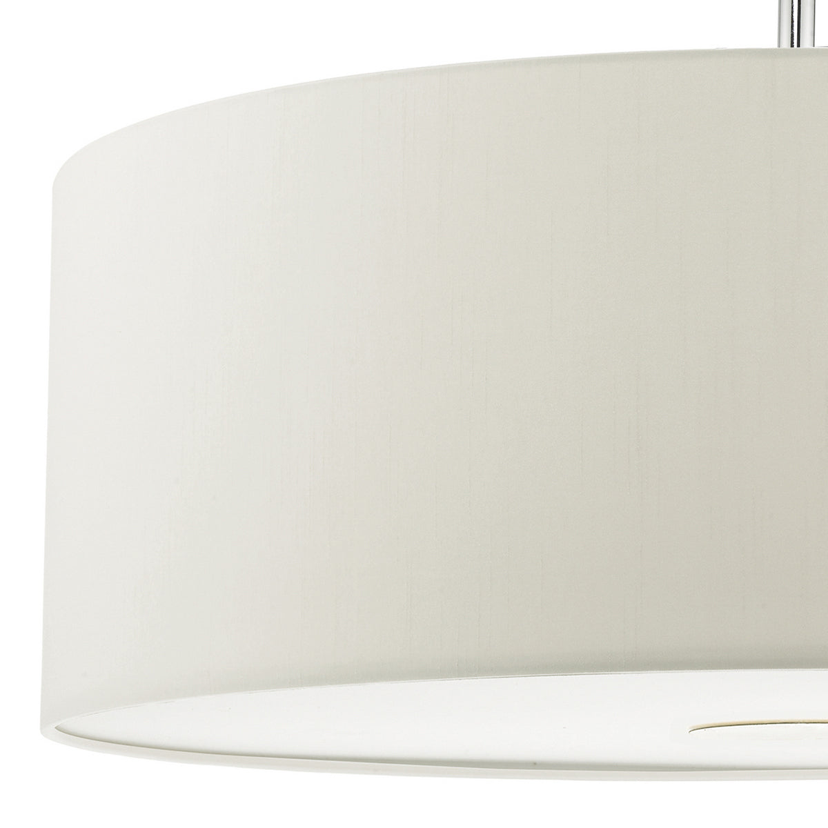 Close-up of a white fabric lampshade with a subtle texture, showing the bottom edge and a hint of the light fixture.