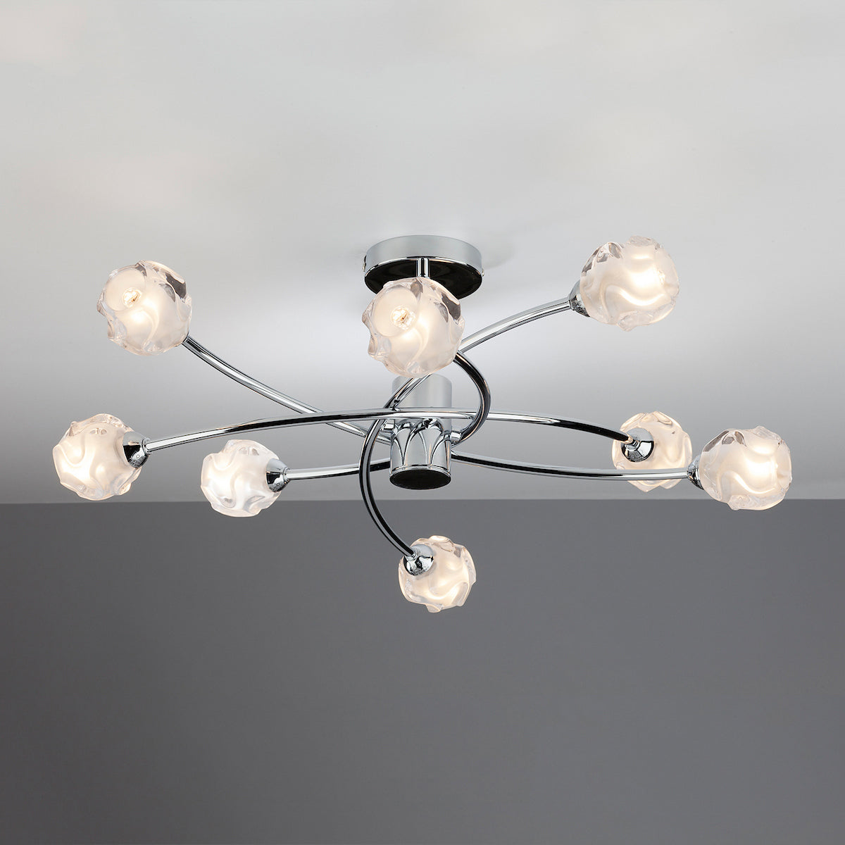 Chrome ceiling light with eight frosted glass shades in a swirling design.