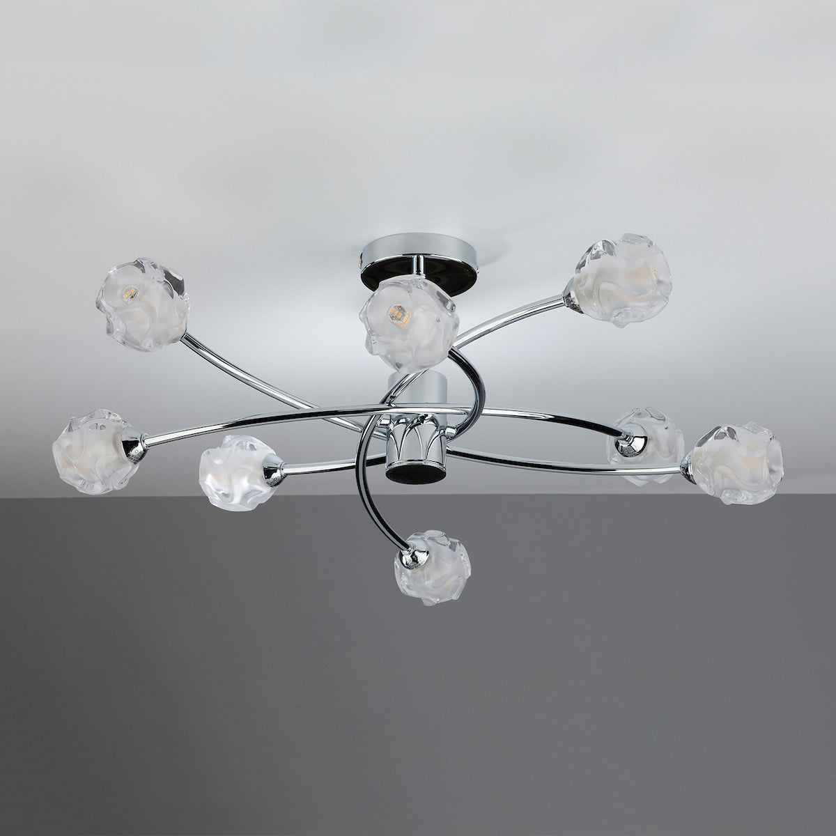 Chrome ceiling light with eight frosted glass shades in a floral design.