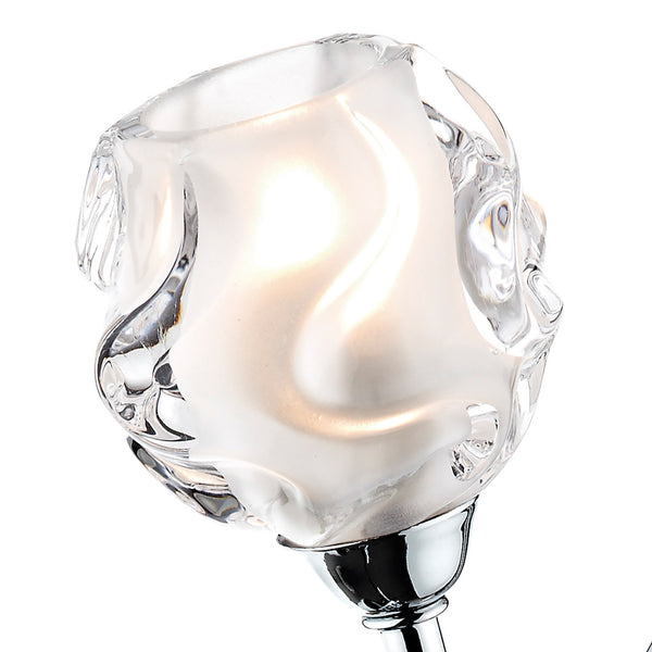 Close-up of a clear glass light fixture with a frosted, wavy interior and a chrome base.