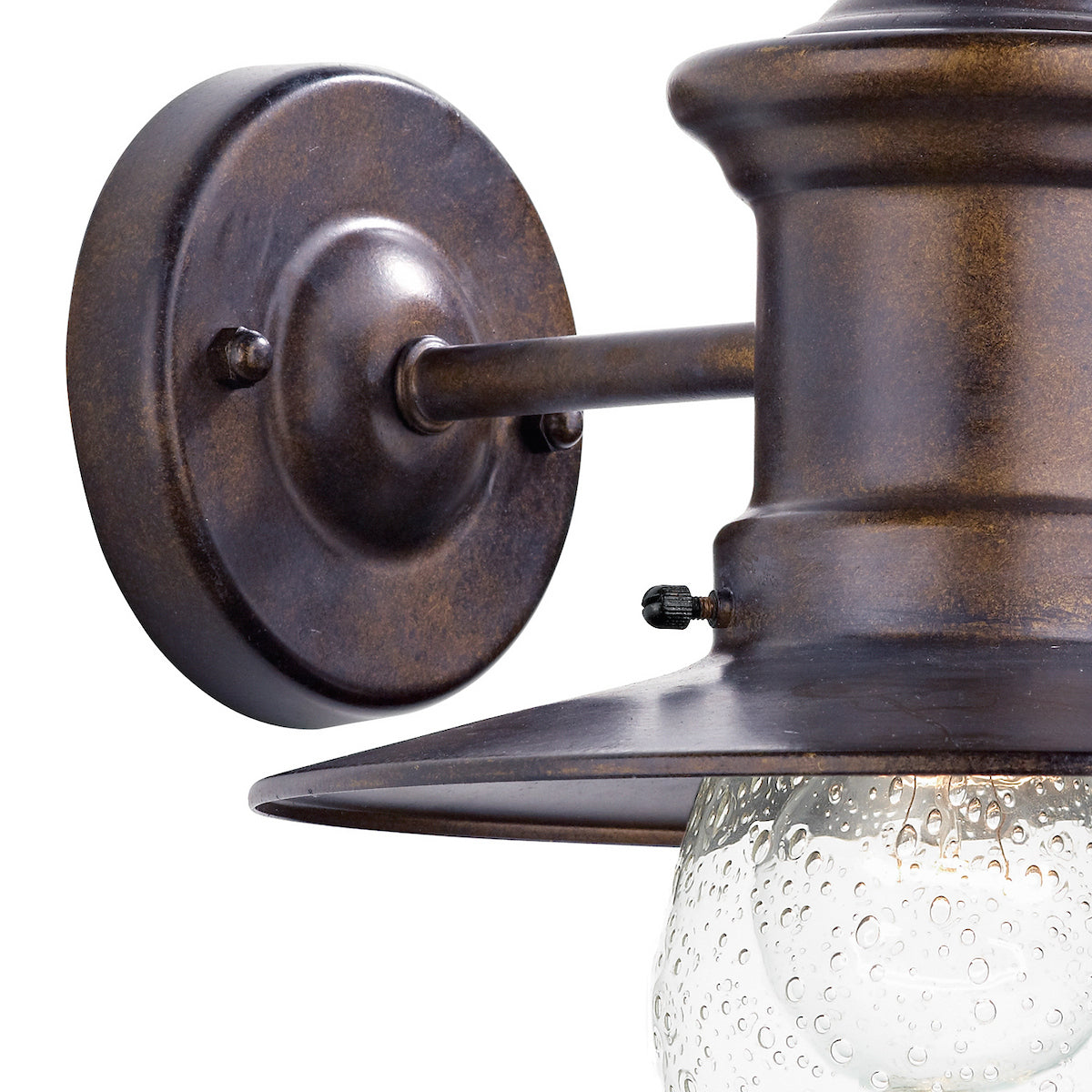 Close-up of a bronze outdoor wall light with a seeded glass shade.
