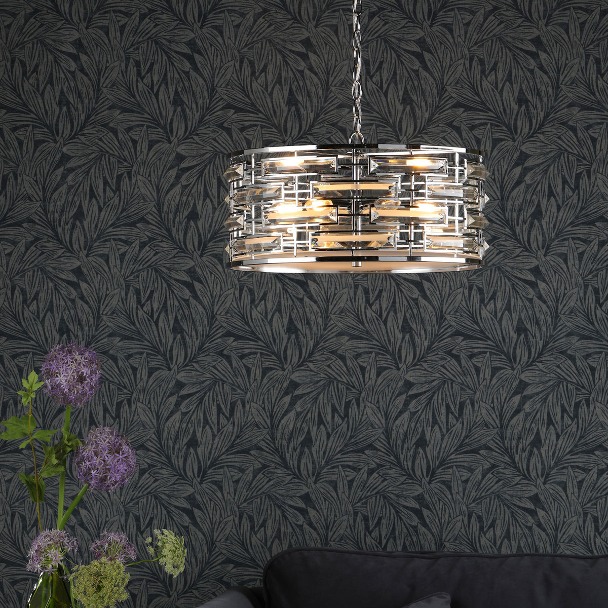 A modern chrome chandelier with rectangular crystal accents hangs from the ceiling.
