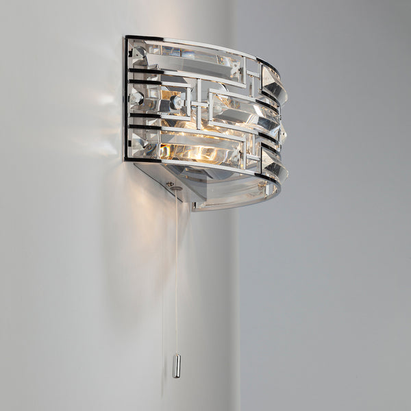 Chrome wall light with clear glass panels and a pull cord switch.