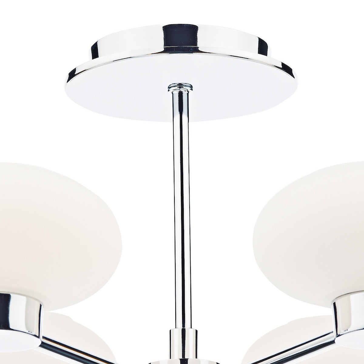 Close-up of a modern chandelier with chrome accents and spherical white glass shades.