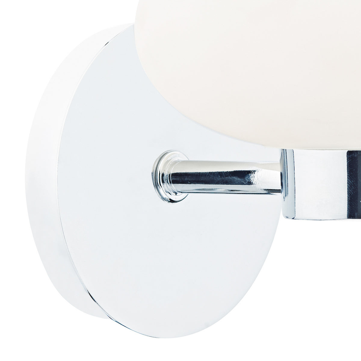 Close-up of a chrome wall sconce with a white spherical light fixture.