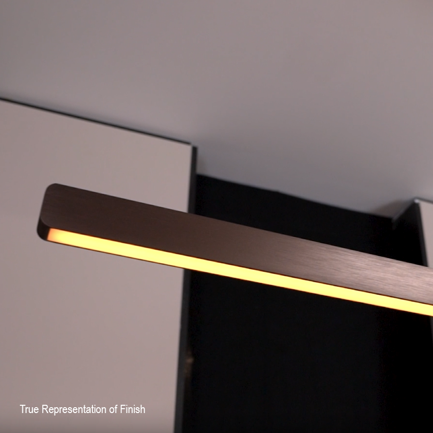 Close up of a bronze linear light fixture with a warm glow