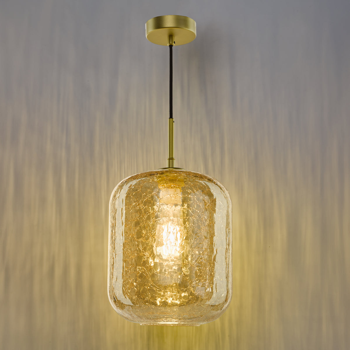 Gold pendant light with a cracked glass shade