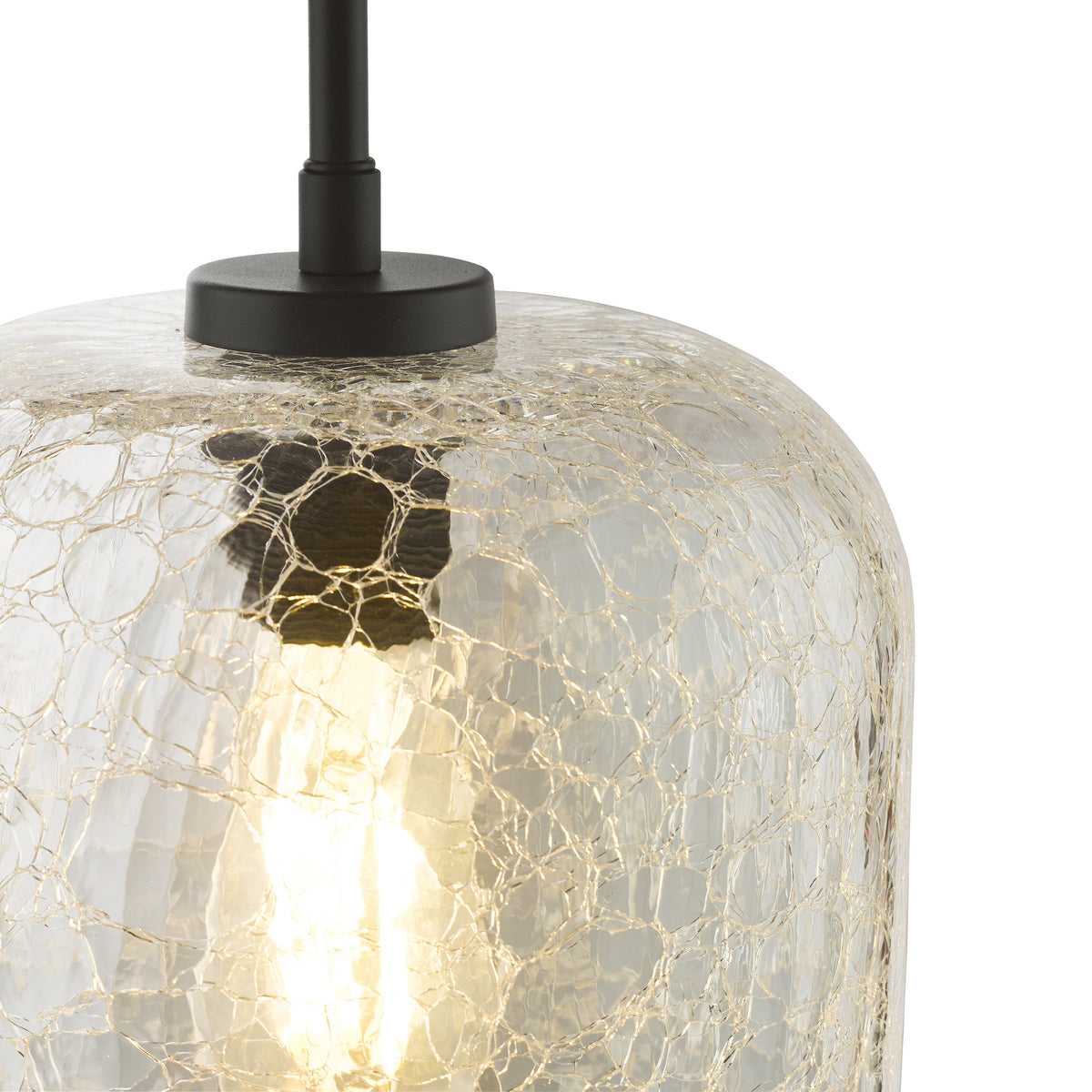 Close-up of a pendant light with a cracked glass shade and an exposed bulb
